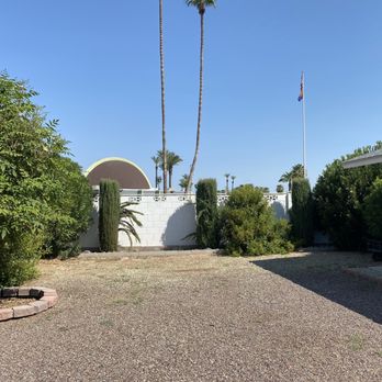 Cosio's Landscaping - a gravel driveway with palm trees in the background - Lawn Services Near Me