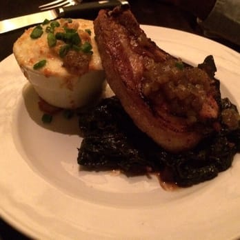 Truffles - Pork chop with collard greens and grits. Yum!! - American Near Me - St. Louis, Missouri Truffles - Pork chop with collard greens and grits. Yum!! - American Near Me - St. Louis, Missouri