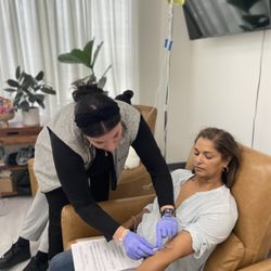 Joy Wellness Partners - IV RN connecting a vitamin drip