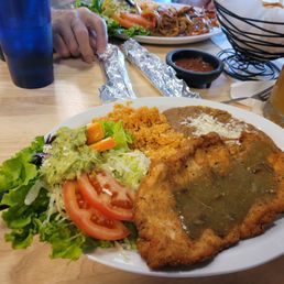 Chicken Milanesa served with rice, beans & a fresh, crisp salad.