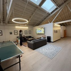 Upstairs: the video game area with sofas, ping pong, changing rooms, and bathroom stalls.