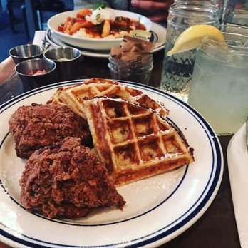 Sweet Chick - Chicken and waffles and boozy lemonade. In the background is the shrimp and grits - Southern Near Me - New York, New York Sweet Chick - Chicken and waffles and boozy lemonade. In the background is the shrimp and grits - Southern Near Me - New York, New York