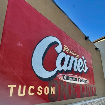 Raising Cane's Chicken Fingers - a sign for a restaurant - Chicken Shop Near Me - Tucson, Arizona Raising Cane's Chicken Fingers - a sign for a restaurant - Chicken Shop Near Me - Tucson, Arizona