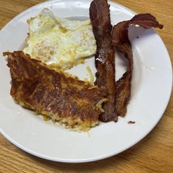 The Stubborn Mule - Two over-easy eggs, with two slices of bacon and a deliciously seasoned hash brown.