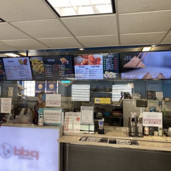 H Mart - a man standing in front of a menu board - Grocery Near Me - North York, Ontario H Mart - a man standing in front of a menu board - Grocery Near Me - North York, Ontario