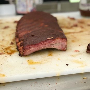 Sm'Oaked BBQ Catering - Temecula - a piece of meat on a cutting board - Caterers Near Me - Temecula, California