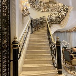 The Palace at Coral Gables - Grandiose staircase with marble steps and black scrolled wrought iron railing adorned in gold leaf