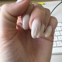 Tech applied a gel overcoat over the dip powder, peeling off and chipping on multiple nails.