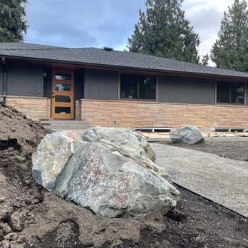 Olympic Rockeries & Construction - a large boulder in front of a house - General Contractors Near Me Olympic Rockeries & Construction - a large boulder in front of a house - General Contractors Near Me
