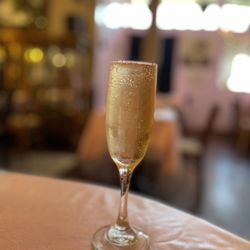 Tyme For Tea & Co - Full glass of peach champagne