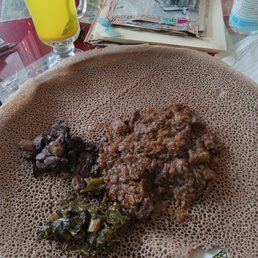 Siga Alicha beef with mushroom and collard greens on Injera with Ginger Boost tea.