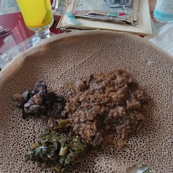 Vera's Kitchen - Siga Alicha beef with mushroom and collard greens on Injera with Ginger Boost tea. - Ethiopian Near Me - Manassas, Virginia