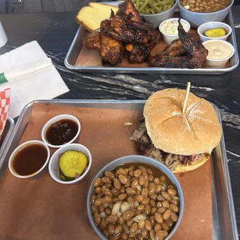 Smoke & Barrels - BBQ Pork Sandwich with baked beans and the Smoked Chicken Wings with baked beans and green beans - Barbeque Near Me - Evans, Georgia Smoke & Barrels - BBQ Pork Sandwich with baked beans and the Smoked Chicken Wings with baked beans and green beans - Barbeque Near Me - Evans, Georgia