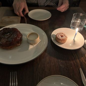Perle Restaurant - Apple tarte tatin (left) with labneh sauce and complimentary berry financier with magic melting candle - New American Near Me - Pasadena, California