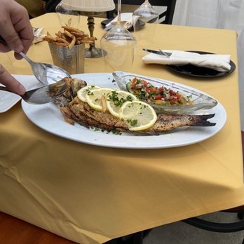 The Standard - Filleting the Bronzino at the table. - French Near Me - Cleveland, Ohio The Standard - Filleting the Bronzino at the table. - French Near Me - Cleveland, Ohio