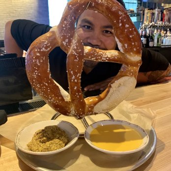 90 NINETY - Josh with the hanging pretzel.....includes a mustard and cheese dipping sauce. Yummy. - New American Near Me - Las Vegas, Nevada