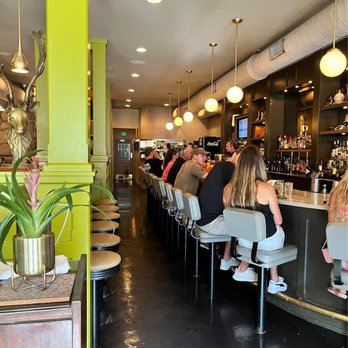 The Rarebit - Bar seating and community table on left! See the diner-look chairs? Love it! - New American Near Me - Charleston, South Carolina