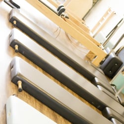 The Pilates Firm Las Vegas - Our official Pilates mats with poles, padding, and foot straps. Credit: Natasha Isom Photography