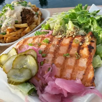 Red Fish Blue Fish - Grilled salmon on salad with a small order of Jerk Fish Poutine - Fish & Chips Near Me - Victoria, British Columbia Red Fish Blue Fish - Grilled salmon on salad with a small order of Jerk Fish Poutine - Fish & Chips Near Me - Victoria, British Columbia