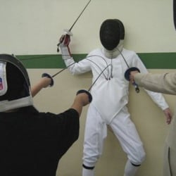 Orange Coast Fencing Academy - After the foil demonstration at the spaghetti dinner, poor William is unceremoniously impaled by the excited participants.