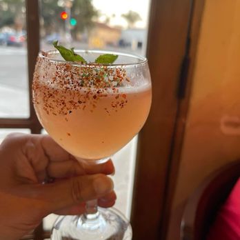 Los Agaves - a person holding a wine glass - New American Near Me - Santa Barbara, California Los Agaves - a person holding a wine glass - New American Near Me - Santa Barbara, California