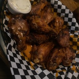 a basket of chicken wings with a side of ranch dip a basket of chicken wings with a side of ranch dip
