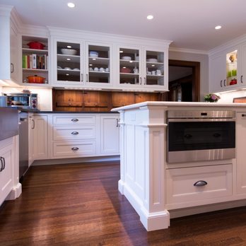 Integrity Building & Design - a kitchen with white cabinets and wood floors - General Contractors Near Me - Acton, Massachusetts