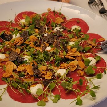 ROC Restaurant - Special for tonight truffle beef carpaccio with toasted almonds, microgreens, parmesan fondue and tableside shaved black truffle. - Italian Near Me - Louisville, Kentucky ROC Restaurant - Special for tonight truffle beef carpaccio with toasted almonds, microgreens, parmesan fondue and tableside shaved black truffle. - Italian Near Me - Louisville, Kentucky