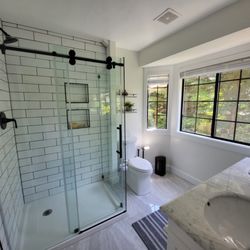 PDX Homeworks - Walk-in corner shower with double niche in 4x10 subway tile. Corner glass shower door.