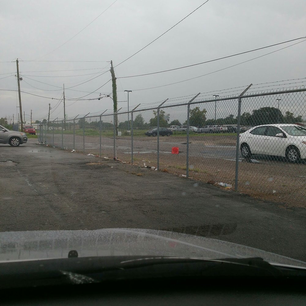 Cell Phone Lot - Trash along the inside of the fence and outside the fence, very tacky! - Parking Near Me - Kenner, Louisiana Cell Phone Lot - Trash along the inside of the fence and outside the fence, very tacky! - Parking Near Me - Kenner, Louisiana