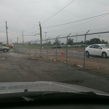 Cell Phone Lot - Trash along the inside of the fence and outside the fence, very tacky! - Parking Near Me - Kenner, Louisiana