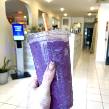 Fittingly Delicious - a hand holding a purple smoothie - Salad Near Me - Chicago, Illinois Fittingly Delicious - a hand holding a purple smoothie - Salad Near Me - Chicago, Illinois