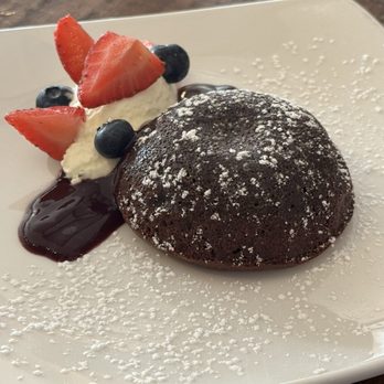 The Roxy Encinitas - MOLTEN CHOCOLATE LAVA CAKE with whipped cream, a berry coulis, fresh berries, and powdered sugar - Tapas/Small Plates Near Me - Encinitas, California