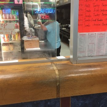 Eddy's Carry Out - a man working behind a counter - New American Near Me - Bladensburg, Maryland Eddy's Carry Out - a man working behind a counter - New American Near Me - Bladensburg, Maryland
