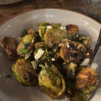 Brighton Bodega - HARISSA ROASTED BRUSSEL SPROUTS (very spicy!! But the sweet dates help to counteract this) - Cocktail Bars Near Me - Brighton, Massachusetts