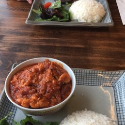 Tomato curry with chicken and rice and salad