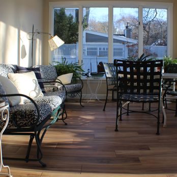 Integrity Building & Design - a sunroom with a table and chairs - General Contractors Near Me - Acton, Massachusetts