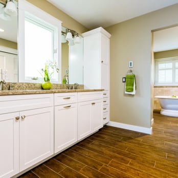 Lincorp/Borchert - a bathroom with white cabinets and marble countertops - General Contractors Near Me - Washington, Michigan