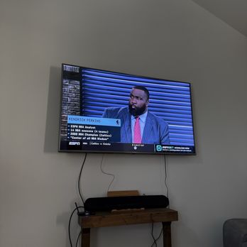 Handyman Construction - Wall mounted television in living room. - General Contractors Near Me