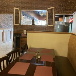 Planet Pizza - Dining room looking toward front of shop.  Nicely done with the wall.  It makes it feel more intimate and not right out in the open