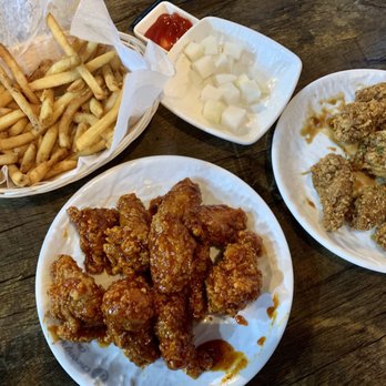 Choong Man Chicken - Spicy garlic wings and soy garlic with a side of regular fries and a complementary radish. - Korean Near Me - Duluth, Georgia