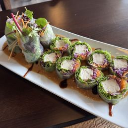 Amazing fresh roll on a bed of peanut sauce Amazing fresh roll on a bed of peanut sauce
