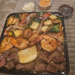 Steak shrimp veggies and noodles and rice