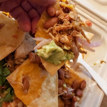 Tacos Hermanos - a hand grabbing a taco from a styrofoam container - Mexican Near Me - Oakland, California Tacos Hermanos - a hand grabbing a taco from a styrofoam container - Mexican Near Me - Oakland, California