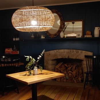 Coast Wine House - a dining room with a table and chairs - Wine Bars Near Me - Dublin, Ohio