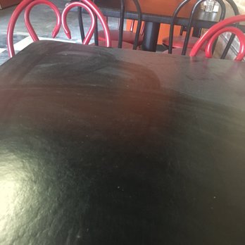 Milano's Pizza - a black table with red chairs - Pizza Near Me - Frankston, Texas Milano's Pizza - a black table with red chairs - Pizza Near Me - Frankston, Texas