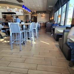 Habit Burger & Grill - Napkins under the table, liquid from garbage to back door while garbage was taken out.