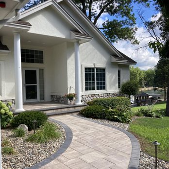 Traxler Hardscapes - A paver driveway with a stoop overlay done in Prior Lake in 2022. - Masonry/Concrete Near Me
