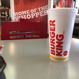 a plastic cup with a straw sitting on a table
