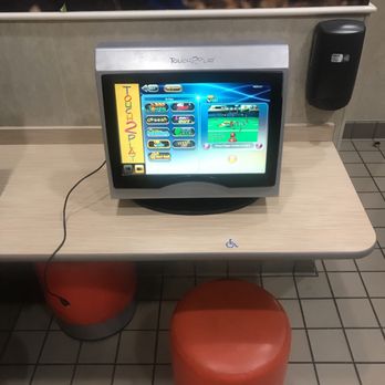 McDonald's - a television on a table with red stools - Burgers Near Me - Old Town, Maine McDonald's - a television on a table with red stools - Burgers Near Me - Old Town, Maine